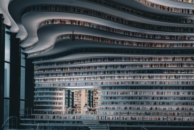 Modern library interior with curved shelves full of books